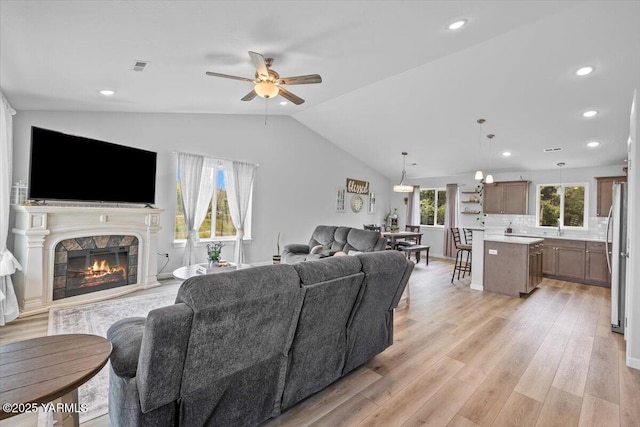 19700 N Beers Rd, Prosser, WA 99350 - living area featuring a ceiling fan, vaulted ceiling, light wood-style floors, a glass covered fireplace, and recessed lighting
