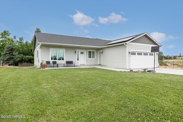 19700 N Beers Rd, Prosser, WA 99350 - ranch-style house featuring an attached garage, a front lawn, roof mounted solar panels, and concrete driveway