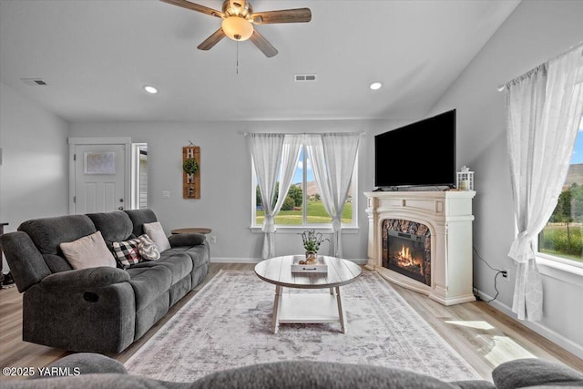 19700 N Beers Rd, Prosser, WA 99350 - living area with light wood-type flooring, ceiling fan, a glass covered fireplace, and recessed lighting