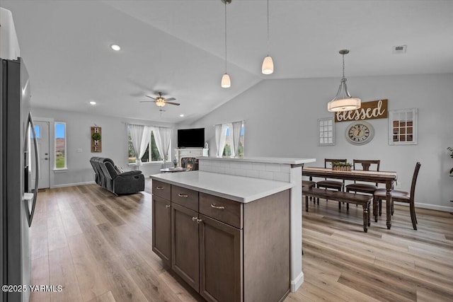 19700 N Beers Rd, Prosser, WA 99350 - kitchen featuring stainless steel refrigerator with ice dispenser, light wood finished floors, a ceiling fan, light countertops, and dark brown cabinetry