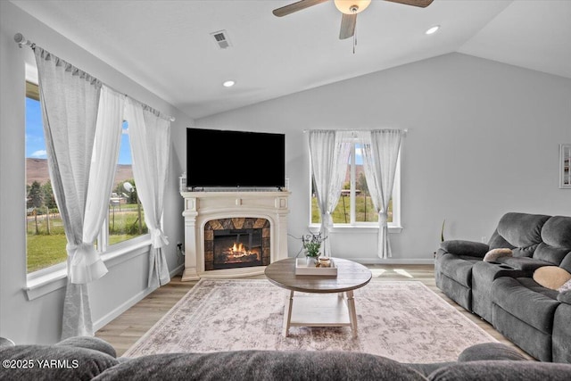 19700 N Beers Rd, Prosser, WA 99350 - living area with lofted ceiling, wood finished floors, a ceiling fan, a stone fireplace, and recessed lighting