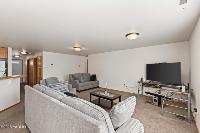 carpeted living area with visible vents and baseboards