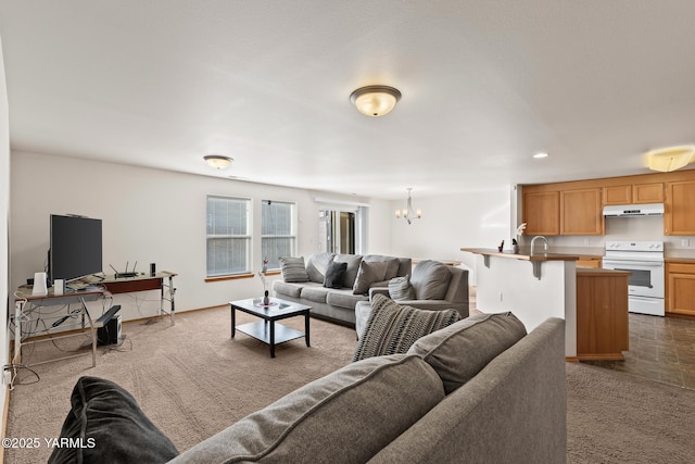 living room featuring an inviting chandelier, dark carpet, and recessed lighting