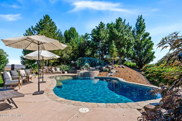 outdoor pool with fence and a patio