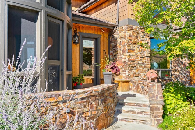 view of exterior entry featuring stone siding