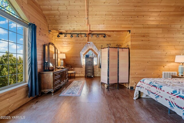 bedroom with wooden walls, visible vents, lofted ceiling, wood ceiling, and wood finished floors