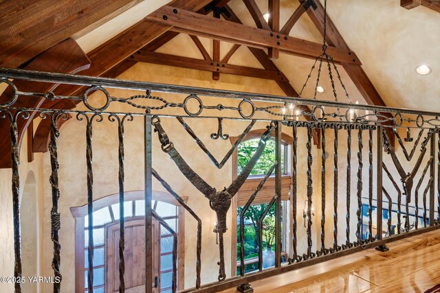 room details featuring an inviting chandelier, arched walkways, and beam ceiling