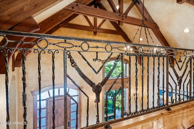 room details featuring an inviting chandelier, arched walkways, and beam ceiling