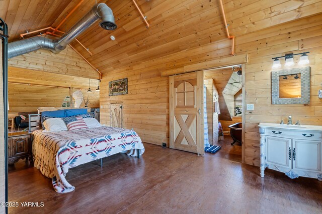 bedroom with wooden walls, wood ceiling, wood finished floors, vaulted ceiling, and a sink