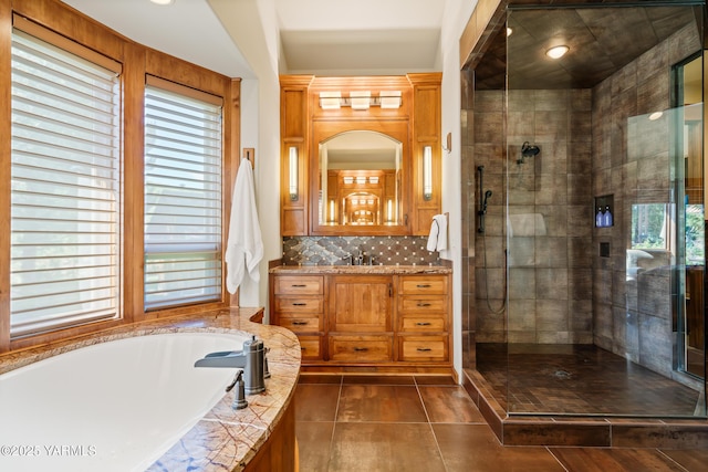 bathroom featuring tiled shower, tile patterned floors, a garden tub, vanity, and backsplash