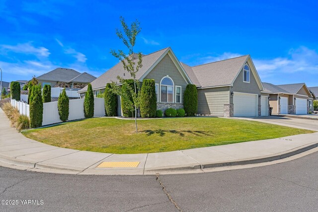 7302 Crown Crest Ave, Yakima, WA 98903 - view of front of home featuring driveway, stone siding, and an attached garage