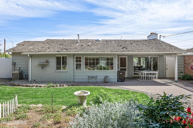 4405 Summitview Ave, Yakima, WA 98908 - back of property with brick siding, a patio, a chimney, and central AC