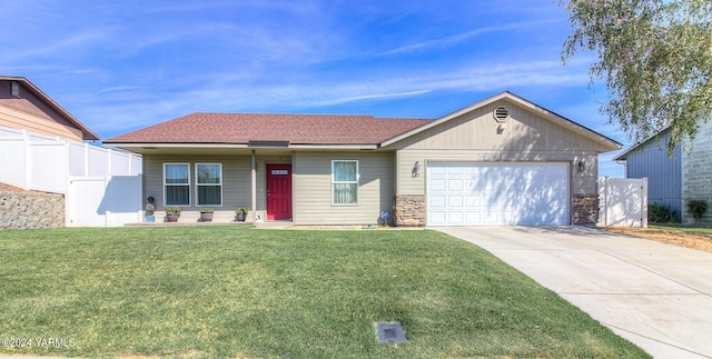 617 Westwind Dr, Zillah, WA 98953 - ranch-style home featuring a front lawn, concrete driveway, fence, and an attached garage