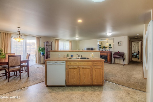 617 Westwind Dr, Zillah, WA 98953 - kitchen with light countertops, a kitchen island with sink, a sink, light carpet, and white appliances