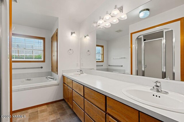 7905 Englewood Ave, Yakima, WA 98908 - full bathroom featuring healthy amount of natural light, double vanity, a garden tub, and a stall shower