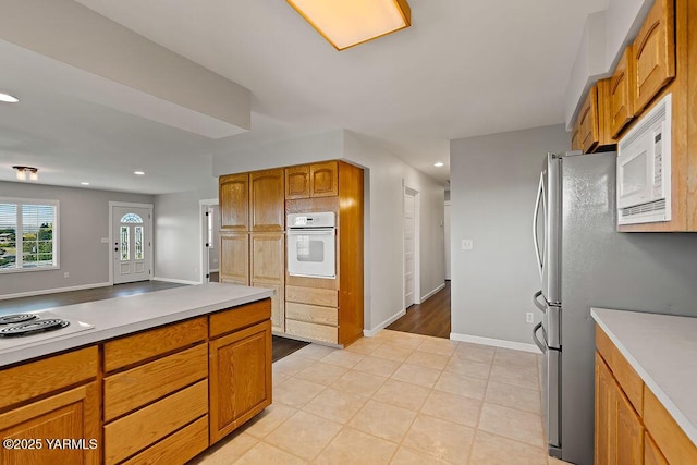 7905 Englewood Ave, Yakima, WA 98908 - kitchen featuring white appliances, light countertops, recessed lighting, brown cabinetry, and baseboards