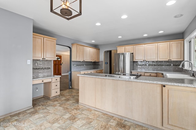 118 Glen Dr, Zillah, WA 98953 - kitchen featuring light brown cabinets, freestanding refrigerator, backsplash, light stone finish floors, and recessed lighting