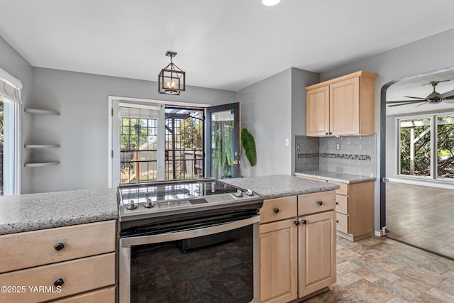 118 Glen Dr, Zillah, WA 98953 - kitchen with electric stove, light brown cabinetry, stone finish flooring, ceiling fan, and decorative backsplash