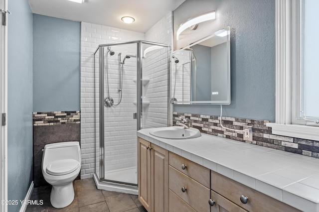 118 Glen Dr, Zillah, WA 98953 - bathroom with vanity, a stall shower, tile patterned floors, and decorative backsplash