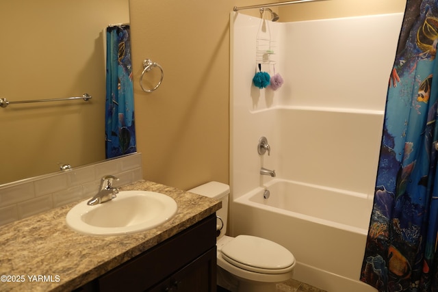 2206 Porter Loop, Yakima, WA 98901 - bathroom featuring toilet, vanity, shower / bath combo with shower curtain, and tasteful backsplash