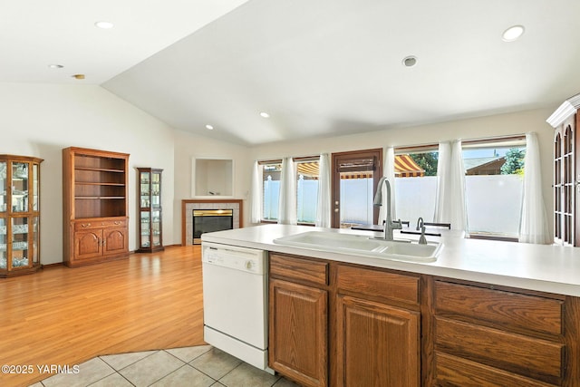 6119 Summitview Ave # 1, Yakima, WA 98908 - kitchen with dishwasher, a tiled fireplace, light countertops, lofted ceiling, and light wood-type flooring