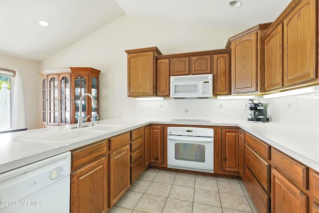 6119 Summitview Ave # 1, Yakima, WA 98908 - kitchen featuring white appliances, vaulted ceiling, decorative backsplash, brown cabinets, and light countertops