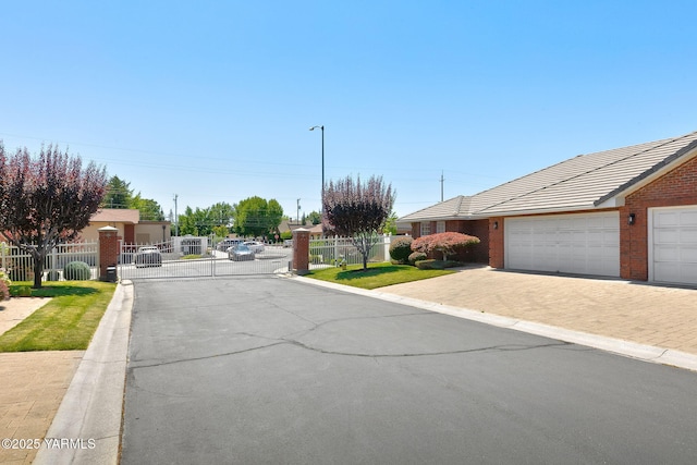 6119 Summitview Ave # 1, Yakima, WA 98908 - view of asphalt road with street lighting, a gate, curbs, and a gated entry
