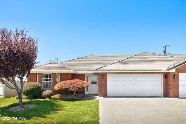 6119 Summitview Ave # 1, Yakima, WA 98908 - view of front of house with an attached garage, brick siding, driveway, a front lawn, and a tile roof