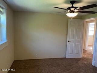 spare room featuring ceiling fan and carpet flooring