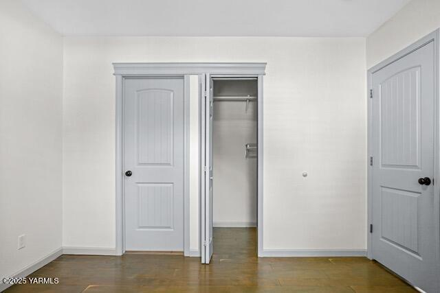 1319 S 15th Ave, Yakima, WA 98902 - unfurnished bedroom featuring baseboards, wood finished floors, and a closet