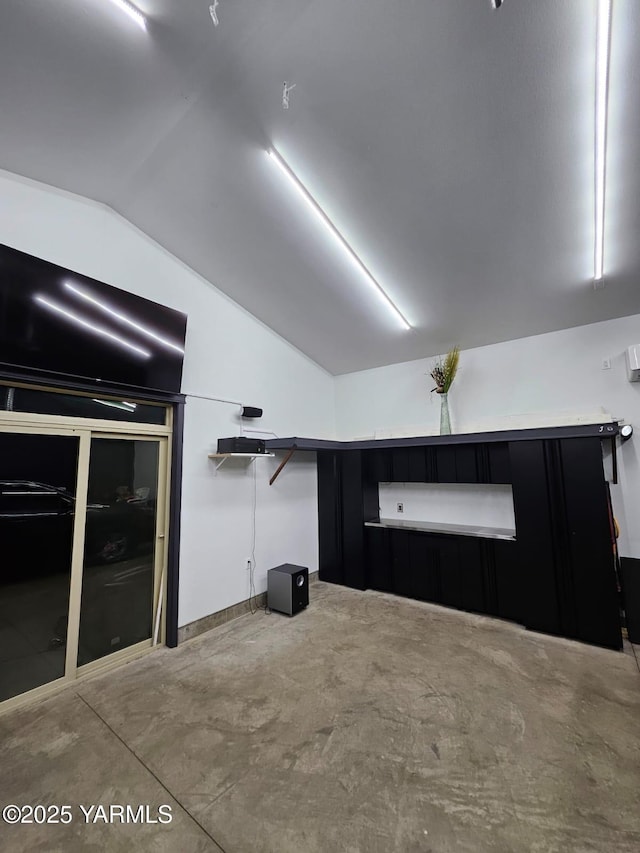 interior space with concrete flooring and vaulted ceiling