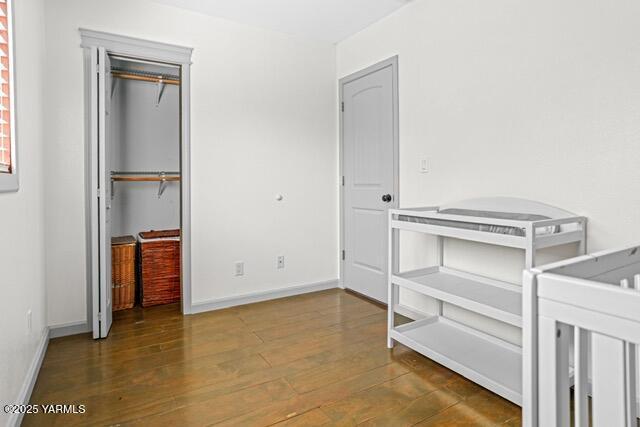 1319 S 15th Ave, Yakima, WA 98902 - unfurnished bedroom featuring wood finished floors, a closet, and baseboards