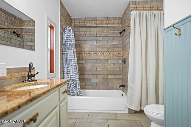 1319 S 15th Ave, Yakima, WA 98902 - bathroom with vanity, shower / bathtub combination with curtain, toilet, and tile patterned floors