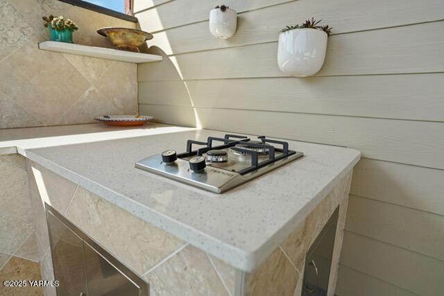 1319 S 15th Ave, Yakima, WA 98902 - kitchen with stainless steel gas stovetop, light countertops, and decorative backsplash