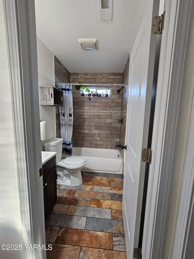 full bath with stone tile flooring, visible vents, toilet, shower / bath combo with shower curtain, and vanity