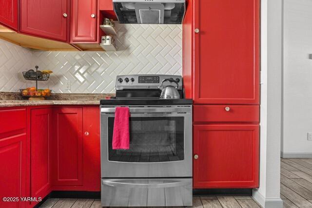 1319 S 15th Ave, Yakima, WA 98902 - kitchen featuring electric range, ventilation hood, red cabinets, backsplash, and light wood-style floors