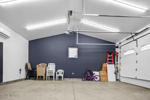 1319 S 15th Ave, Yakima, WA 98902 - garage featuring a garage door opener and a wall mounted AC