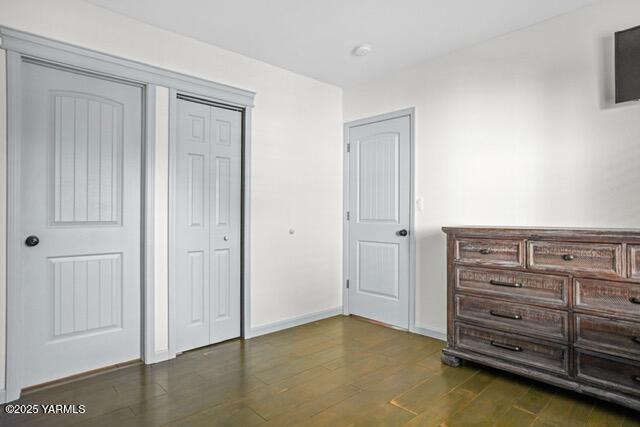 1319 S 15th Ave, Yakima, WA 98902 - unfurnished bedroom featuring dark wood-style floors and baseboards