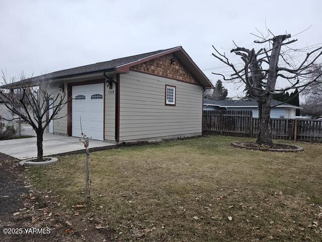 view of outbuilding with a garage and fence