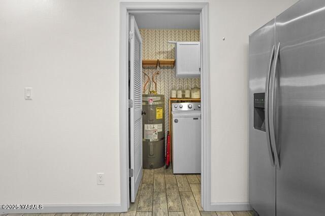1319 S 15th Ave, Yakima, WA 98902 - kitchen featuring stainless steel refrigerator with ice dispenser, washer / dryer, light wood-style flooring, secured water heater, and baseboards
