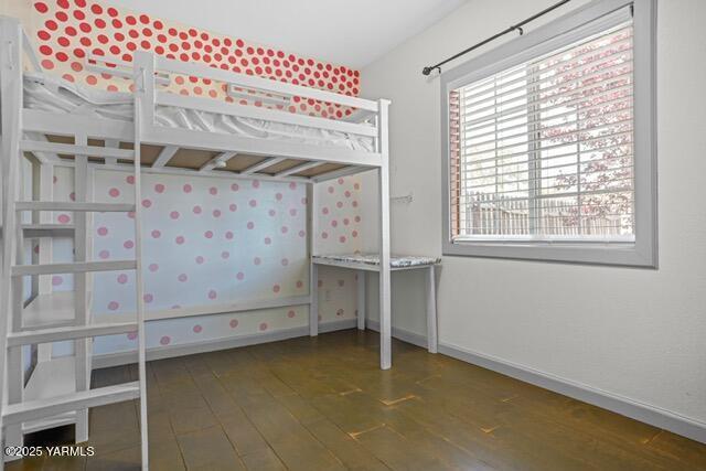 1319 S 15th Ave, Yakima, WA 98902 - unfurnished bedroom with hardwood / wood-style flooring and baseboards