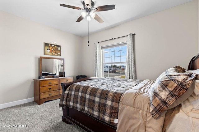 bedroom with light carpet, a ceiling fan, and baseboards