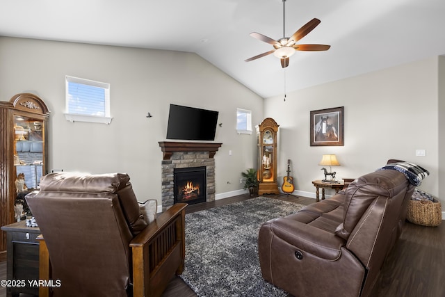 living area with lofted ceiling, dark wood-style flooring, a fireplace, and a wealth of natural light