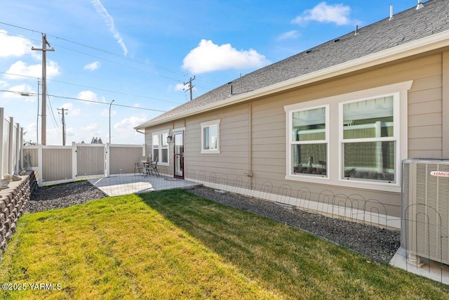 view of yard featuring a patio, cooling unit, a gate, and fence