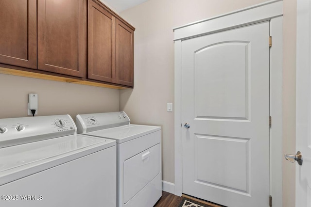 clothes washing area featuring separate washer and dryer and cabinet space