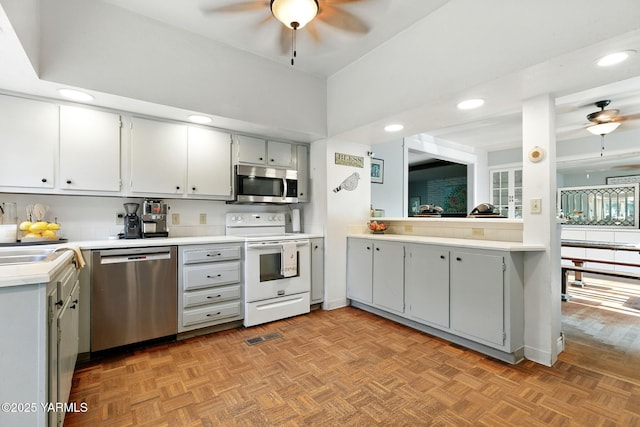 2810 Butterfield Rd, Yakima, WA 98901 - kitchen with stainless steel appliances, ceiling fan, gray cabinets, and recessed lighting