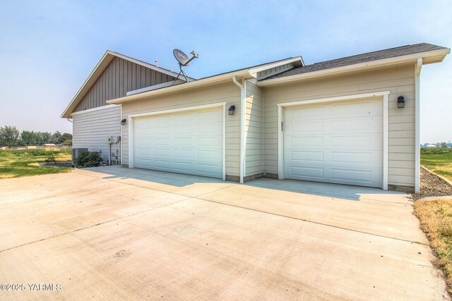 garage featuring concrete driveway