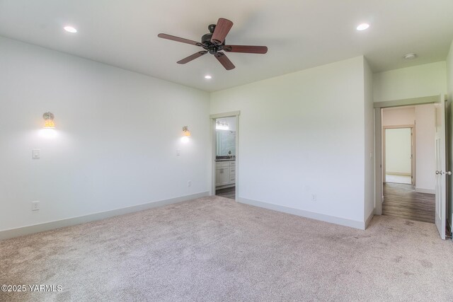 unfurnished bedroom featuring ensuite bath, carpet flooring, recessed lighting, and baseboards