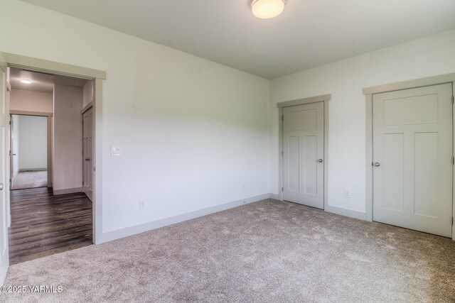 unfurnished bedroom with baseboards and carpet flooring