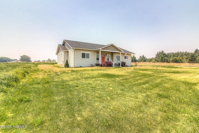 view of front of home with a porch and a front lawn